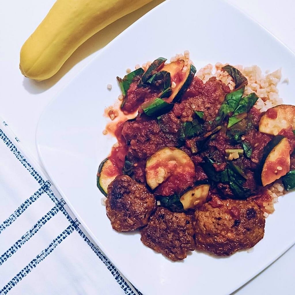 Italian Sausage Marinara served over cauliflower rice for keto low carb, or rice, or quinoa, topped with zucchini and collar greens.
