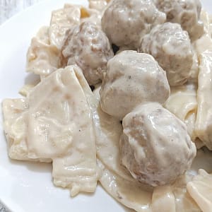 Swedish Meatballs with thick Amish egg noodles, homestyle meatballs, and a creamy sauce.